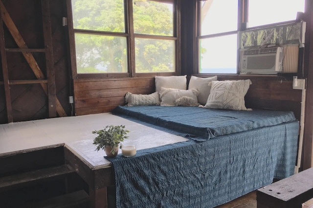 bedroom featuring wooden walls