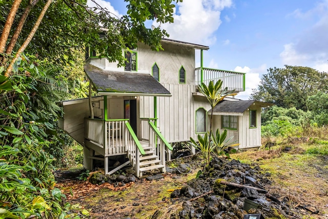 back of property featuring a balcony