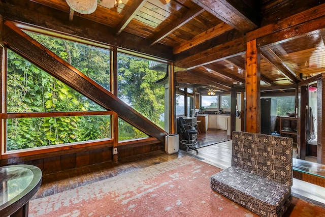 unfurnished sunroom featuring lofted ceiling with beams and wooden ceiling