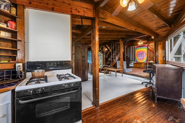 kitchen with wooden ceiling, vaulted ceiling with beams, hardwood / wood-style flooring, and gas range gas stove