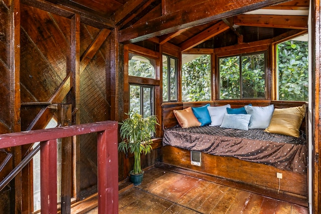 unfurnished bedroom featuring wood-type flooring and vaulted ceiling