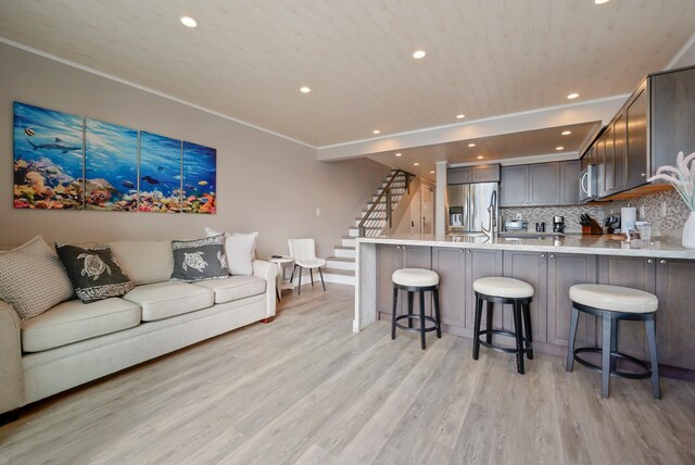 living room featuring recessed lighting, light wood-style flooring, stairs, and wooden ceiling