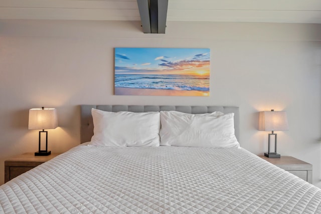 bedroom with beam ceiling