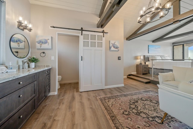 full bathroom featuring lofted ceiling with beams, toilet, baseboards, a notable chandelier, and wood finished floors