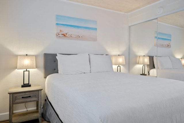 bedroom with baseboards and ornamental molding