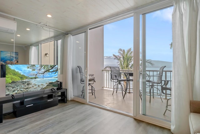 interior space featuring recessed lighting, wood finished floors, and a wall mounted air conditioner