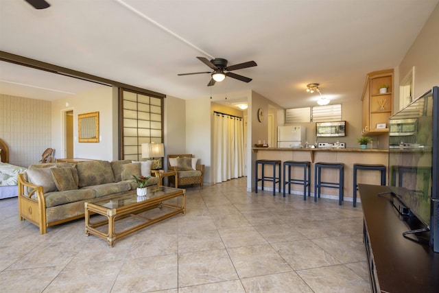 living room featuring ceiling fan and light tile patterned floors