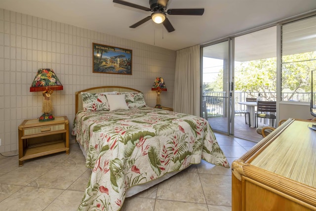 tiled bedroom featuring tile walls, ceiling fan, access to exterior, and multiple windows