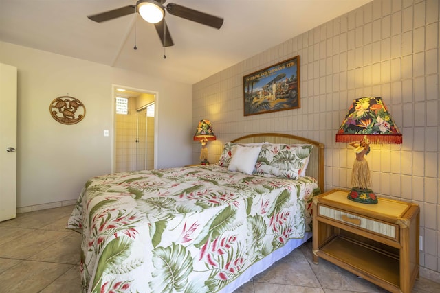 tiled bedroom featuring tile walls and ceiling fan