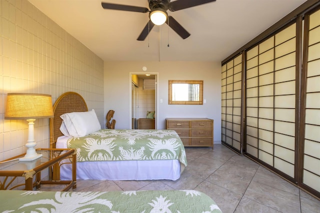 bedroom with ceiling fan and light tile patterned floors