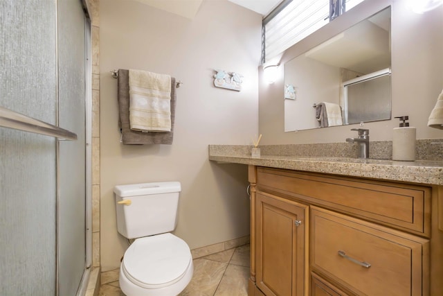 bathroom featuring toilet, tile patterned floors, walk in shower, and vanity