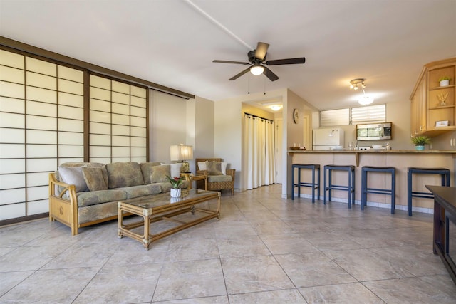 living room with light tile patterned flooring and ceiling fan