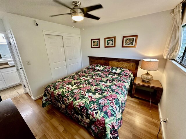 bedroom featuring light hardwood / wood-style flooring, ceiling fan, and a closet