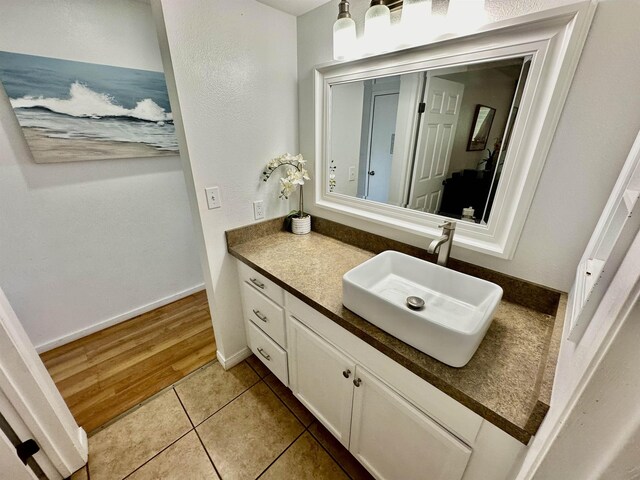 bathroom featuring tile patterned flooring and vanity