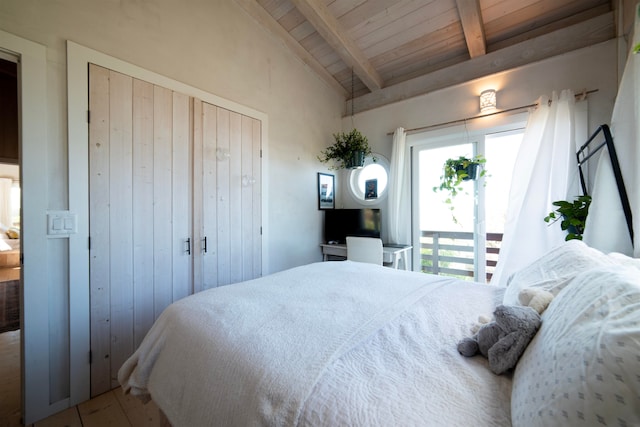 bedroom with vaulted ceiling with beams and wooden ceiling