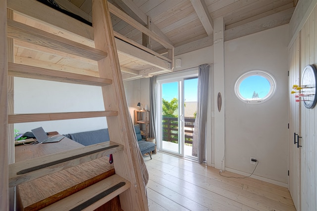 doorway with light hardwood / wood-style floors, wooden ceiling, and lofted ceiling with beams