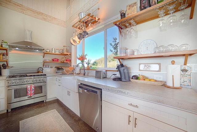 kitchen with appliances with stainless steel finishes, island exhaust hood, white cabinetry, and sink