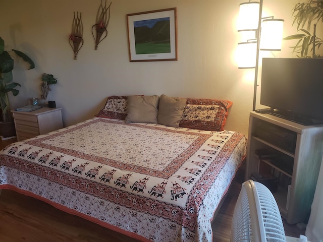 bedroom with dark hardwood / wood-style flooring