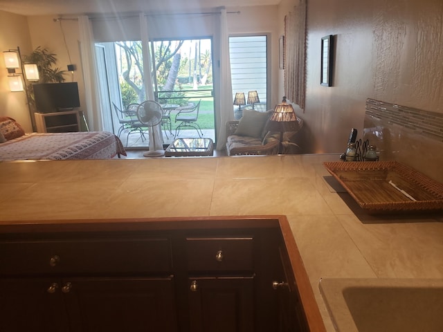 kitchen featuring tile flooring and dark brown cabinetry