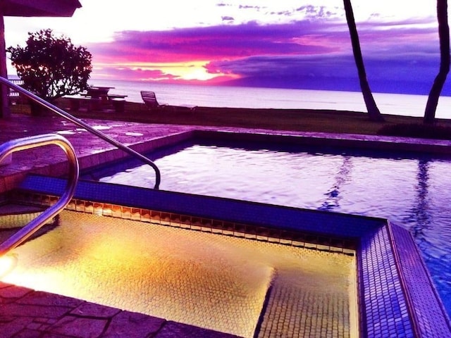 pool at dusk with a water view