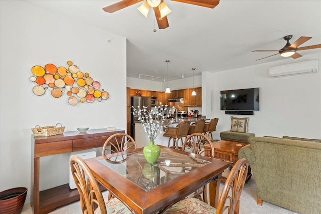 dining space featuring sink, a wall mounted air conditioner, and ceiling fan