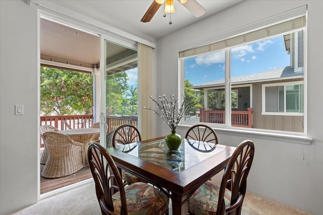 carpeted dining area featuring ceiling fan