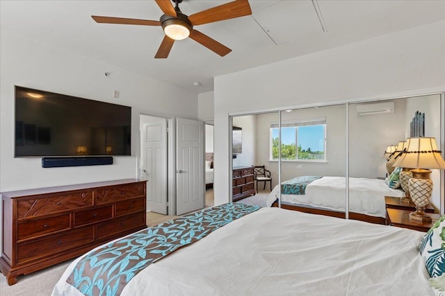 bedroom with a closet, ceiling fan, light carpet, and a wall unit AC