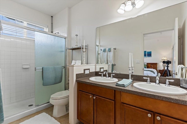 bathroom with toilet, tile patterned flooring, walk in shower, and vanity