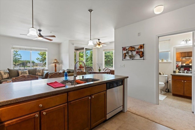 kitchen featuring sink, light tile patterned flooring, pendant lighting, and appliances with stainless steel finishes