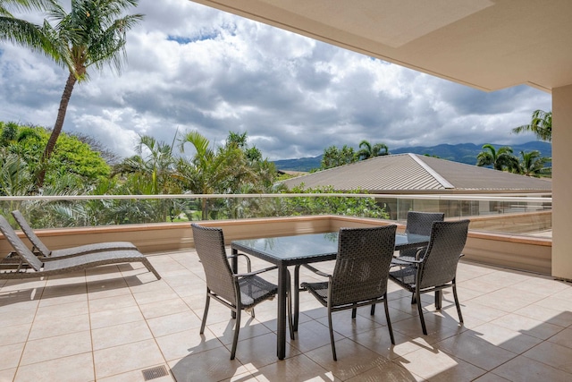 view of patio featuring a balcony and a mountain view