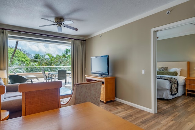 dining space featuring a textured ceiling, ceiling fan, and hardwood / wood-style floors