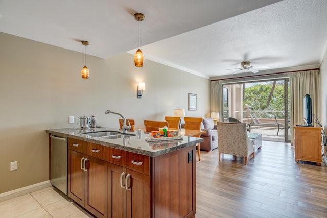 kitchen featuring a textured ceiling, stainless steel dishwasher, light hardwood / wood-style flooring, sink, and ceiling fan