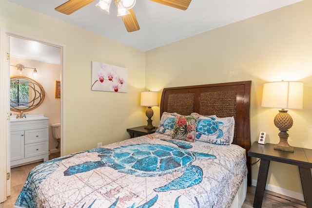 2219 S Kihei Rd Unit B312, Kihei, HI 96753 - bedroom featuring wood finished floors, connected bathroom, a ceiling fan, baseboards, and a sink