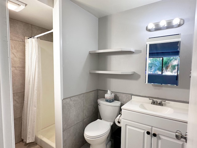 bathroom featuring a shower with shower curtain, vanity, toilet, and tile walls