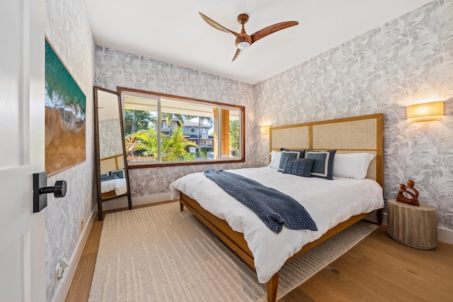 bedroom with ceiling fan and light hardwood / wood-style floors