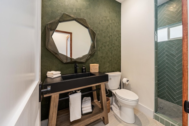 bathroom with tile patterned floors, sink, an enclosed shower, and toilet