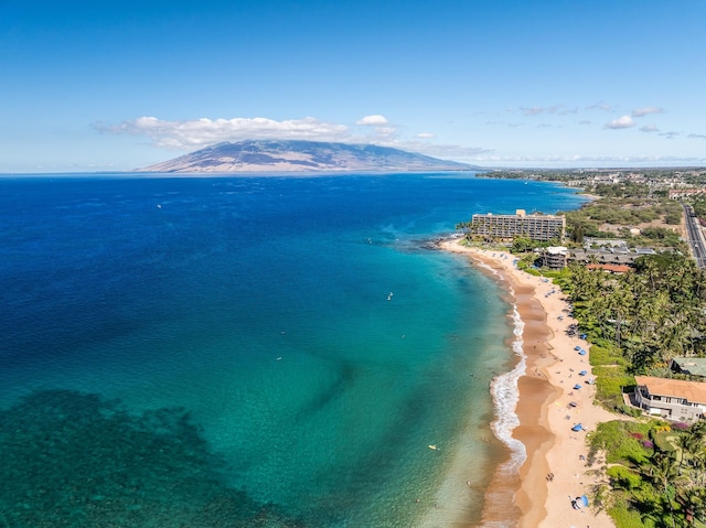 birds eye view of property featuring a water and mountain view and a view of the beach