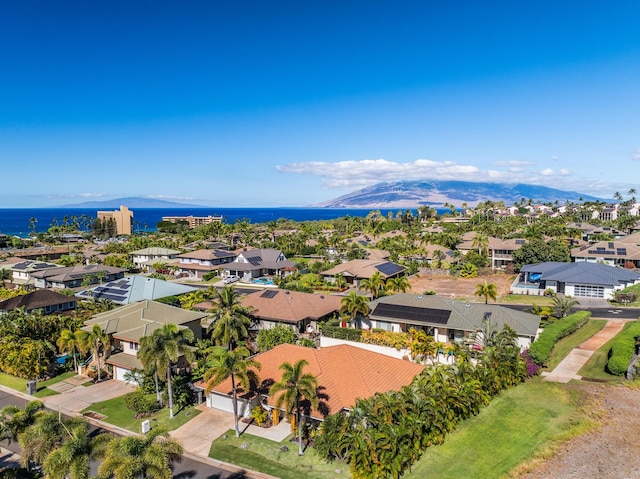 drone / aerial view with a water and mountain view