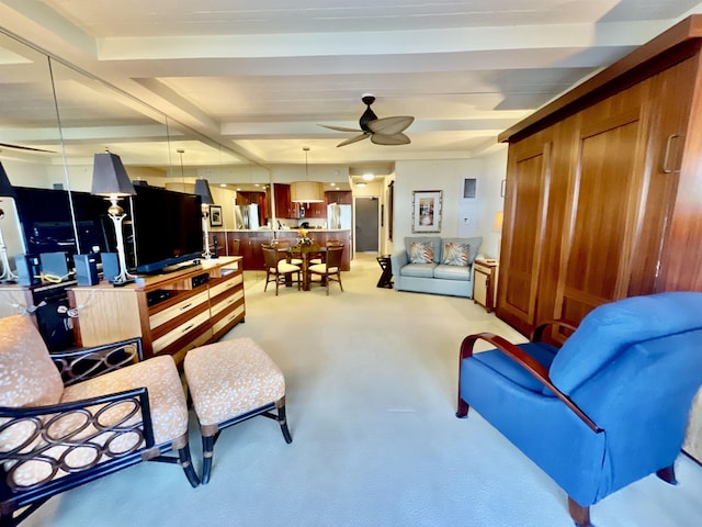 carpeted living room with beam ceiling and ceiling fan