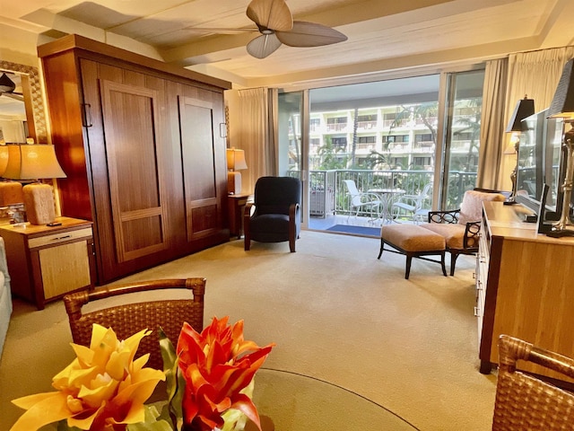 sitting room with light colored carpet and ceiling fan