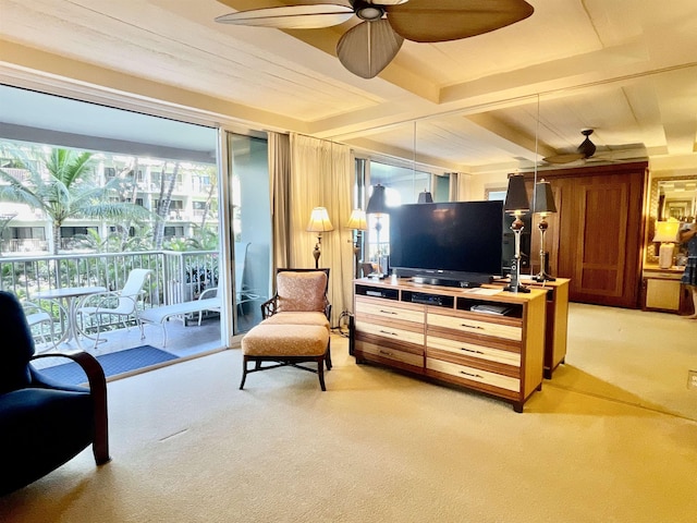 living area with carpet floors, plenty of natural light, and beam ceiling