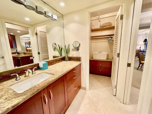 bathroom featuring tile patterned floors, decorative backsplash, and vanity