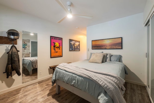 bedroom featuring hardwood / wood-style floors, ceiling fan, and a closet