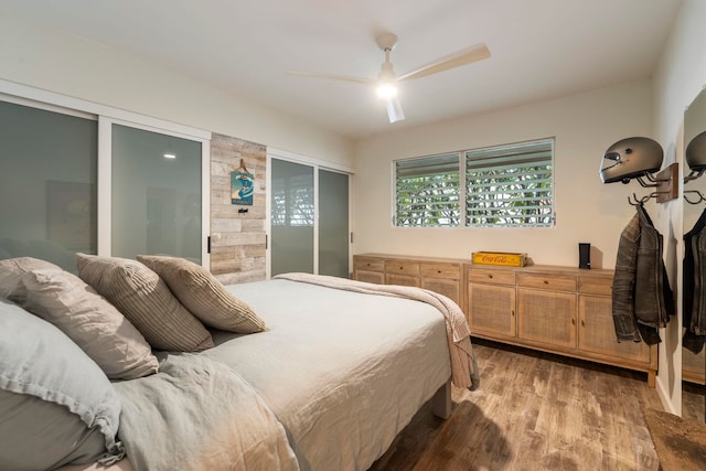 bedroom featuring connected bathroom, ceiling fan, and wood-type flooring