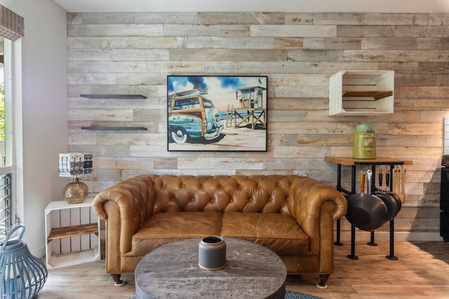 living room with hardwood / wood-style floors, a wealth of natural light, and wood walls