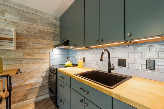 kitchen featuring sink, range hood, black / electric stove, dark hardwood / wood-style flooring, and butcher block counters