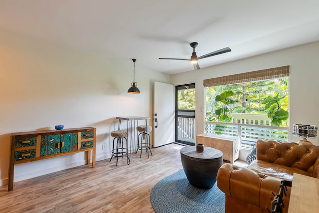 living room featuring light wood-type flooring and ceiling fan