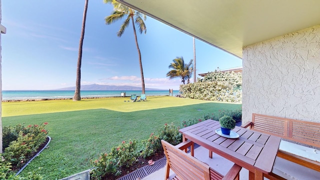 view of yard featuring a water view and a view of the beach