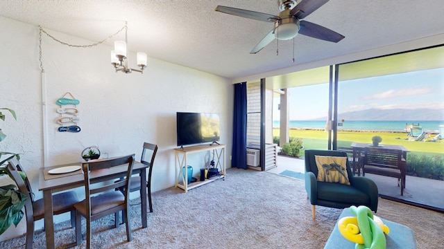 carpeted living room featuring ceiling fan with notable chandelier and a textured ceiling