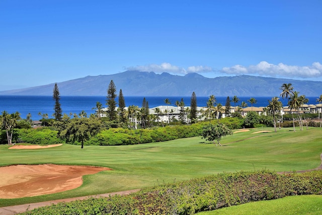 view of community with a water and mountain view and a yard